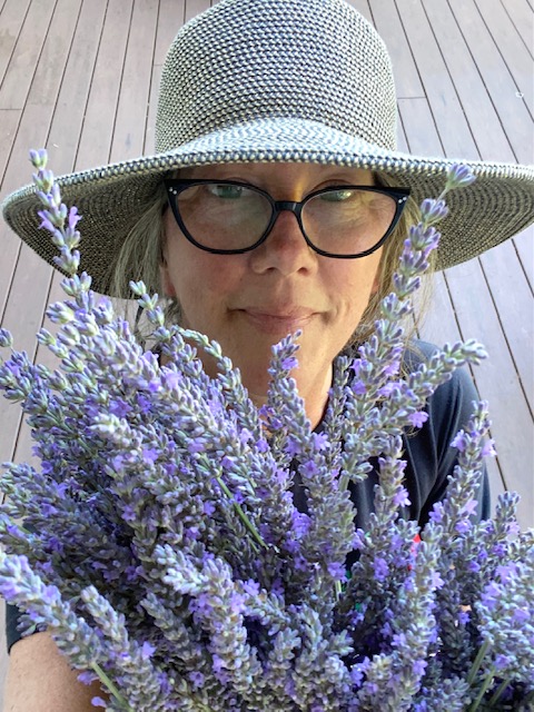 Picture of Angie holding bundles of lavender