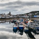 Photo of an inlet filled with fishing boats in Tarbert Scotland