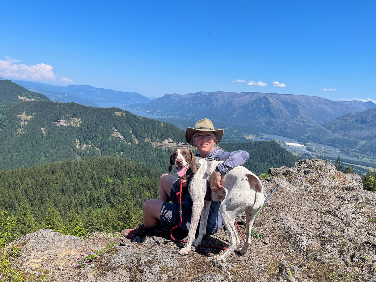 Angie Windheim and Rosie her dog at the ridge of Hamilton Mountain with Columbia River below.